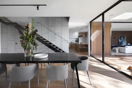 Image of a kitchen overlooking a living room, showing both spaces and their respective furnishings.